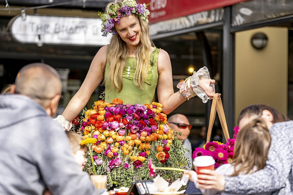 Flower girl handing out flowers