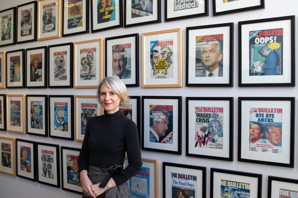 Jane angel in front of wall of bob hawke pictures