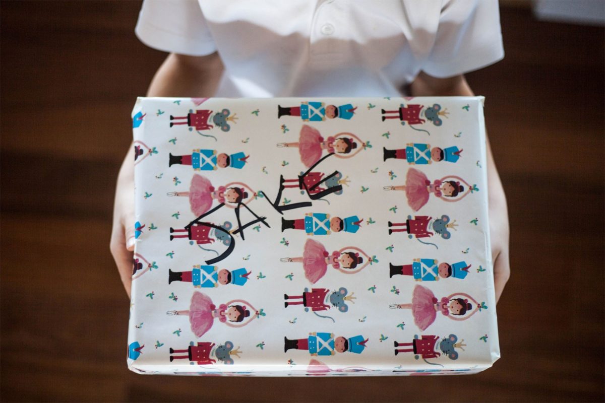 A wrapped present held in a childs hands