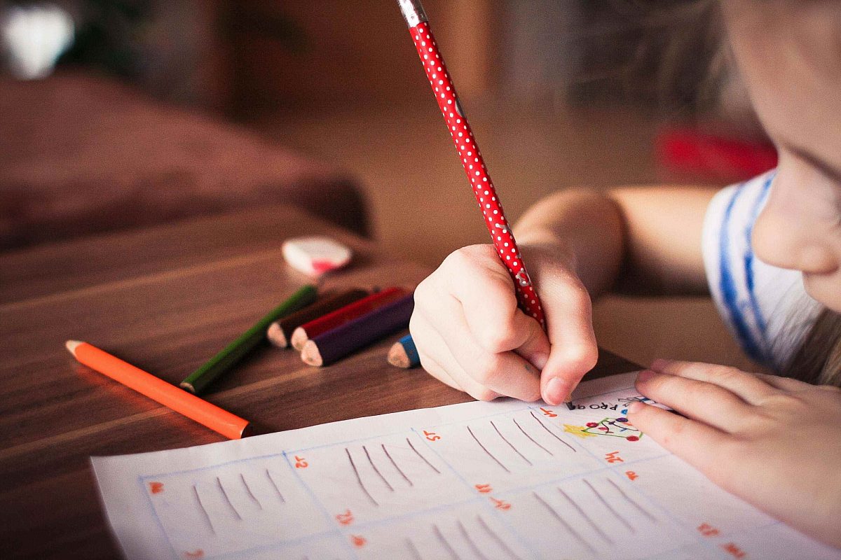 Close up girl writing at desk