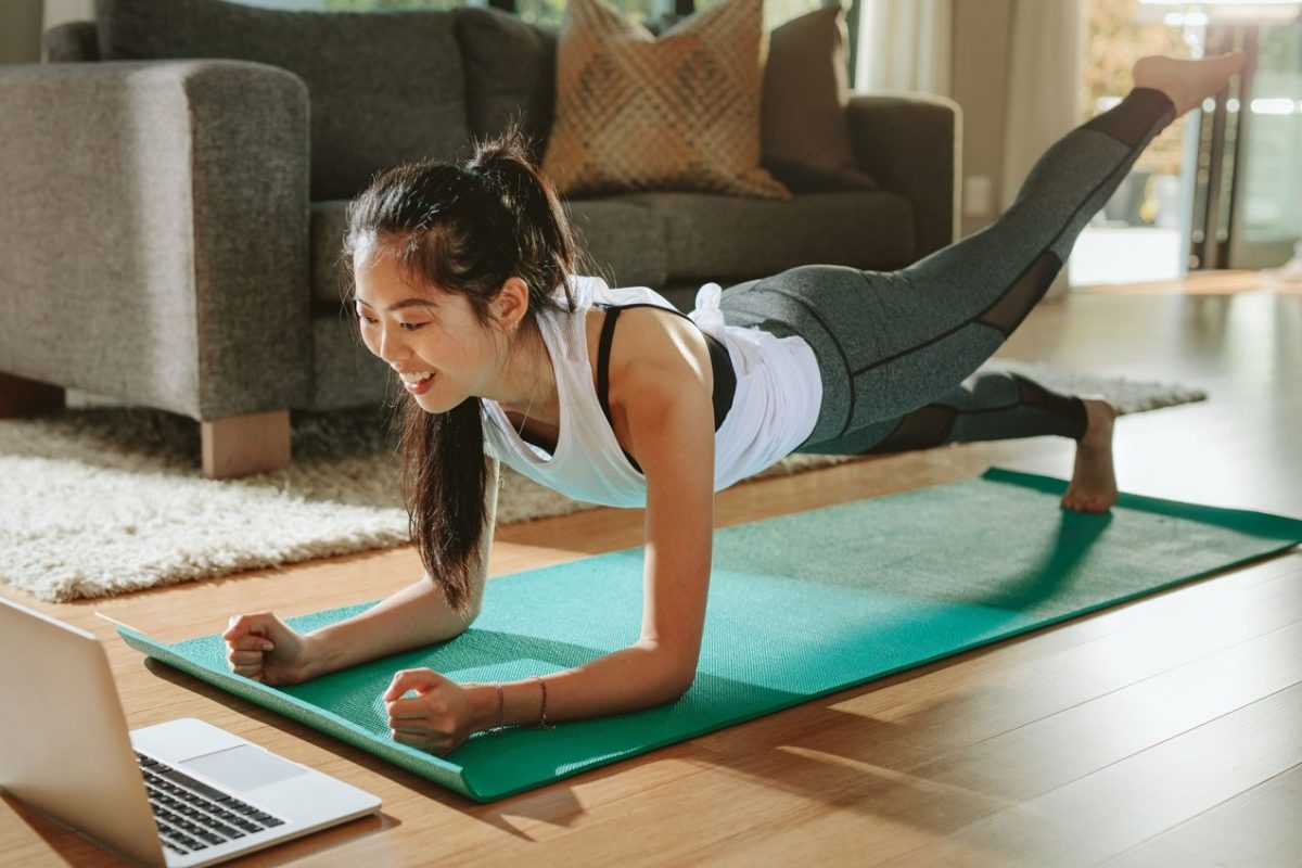 Young girl yoga pilates green mat home